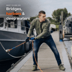 Lifestyle image of a magnet fishing enthusiast using a powerful recovery magnet from a harbor dock, ideal for bridges, harbors and deep water magnet fishing spots