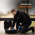 Lifestyle image of a professional magnet fisher using the Mega Cube magnet fishing kit with hard case, rope, gloves and neodymium cube magnet by the water's edge