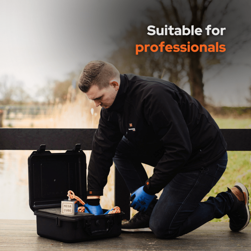 Lifestyle image of a professional magnet fisher using the Mega Cube magnet fishing kit with hard case, rope, gloves and neodymium cube magnet by the water's edge
